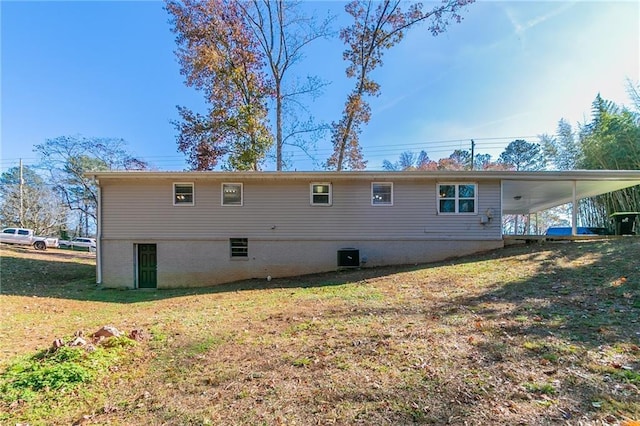 8775 Lee Rd, Lithia Springs, GA 30122 - back of house with a lawn, cooling unit, and a carport