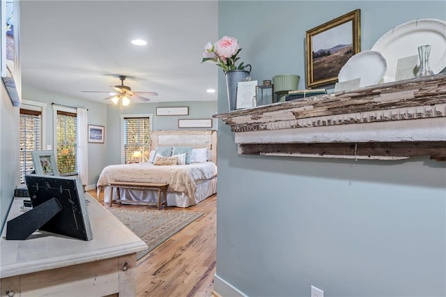 bedroom with recessed lighting, baseboards, and wood finished floors