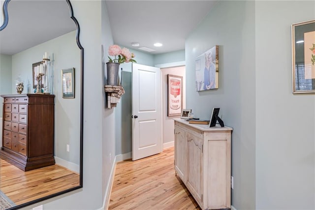 corridor with recessed lighting, baseboards, and light wood-style floors