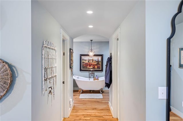 hallway with recessed lighting, light wood-style flooring, and baseboards