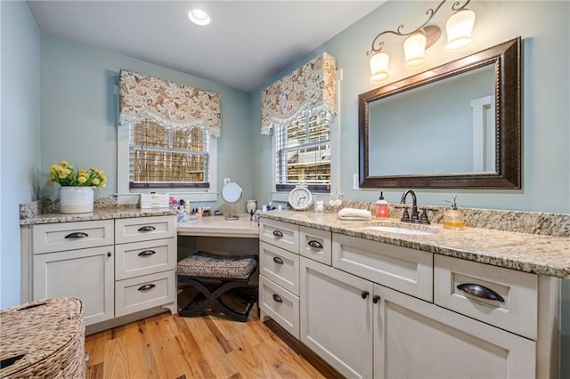 bathroom with vanity, recessed lighting, and wood finished floors