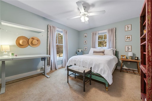 carpeted bedroom featuring ceiling fan and baseboards