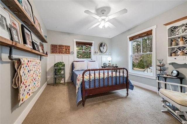 bedroom with light colored carpet, baseboards, and ceiling fan
