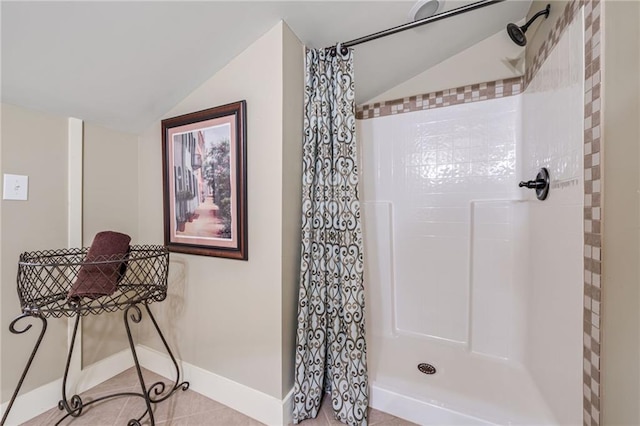 full bathroom featuring baseboards, vaulted ceiling, and a shower with shower curtain