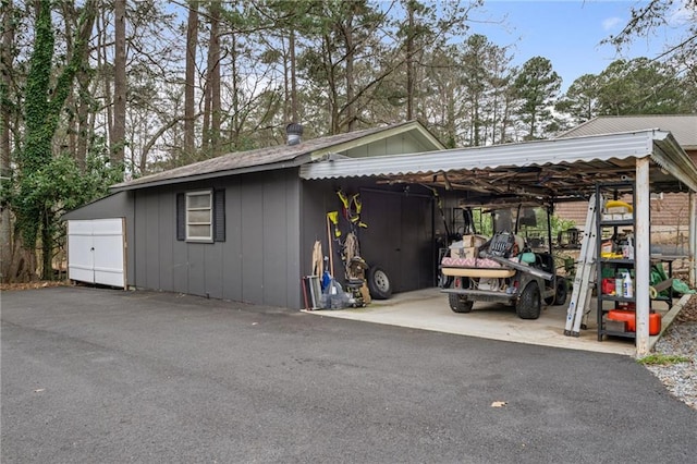 exterior space with board and batten siding and an attached carport