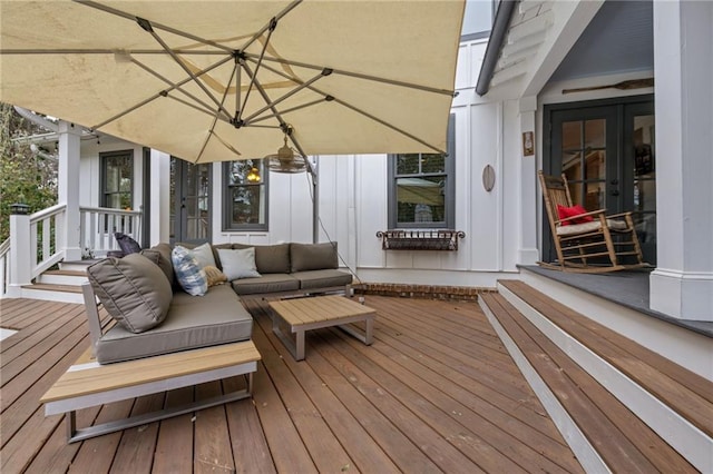 wooden terrace featuring french doors and an outdoor living space