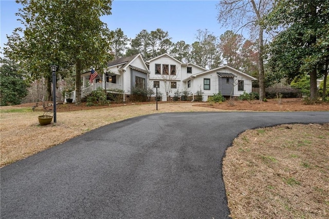 view of front facade with a front lawn and aphalt driveway