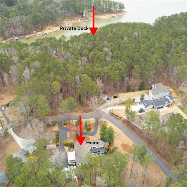 birds eye view of property featuring a wooded view