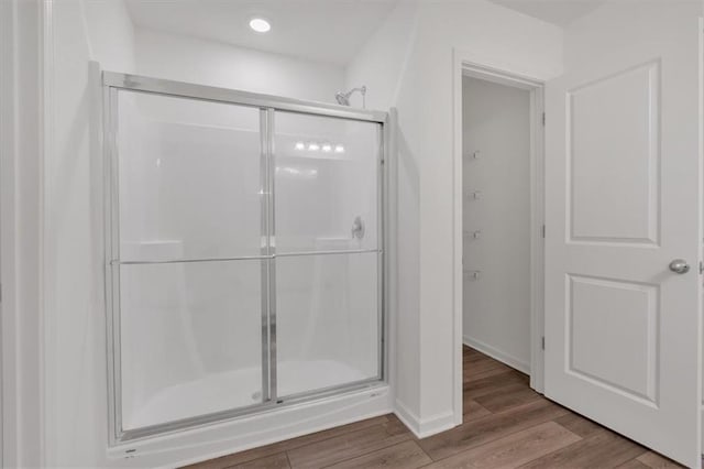 bathroom featuring walk in shower and hardwood / wood-style floors