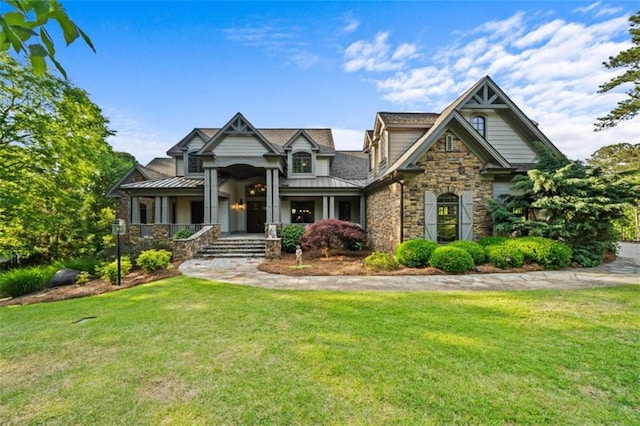 craftsman inspired home featuring a standing seam roof, metal roof, and a front lawn