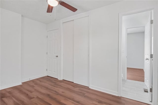 unfurnished bedroom with hardwood / wood-style floors and ceiling fan