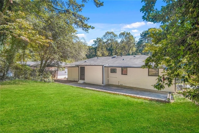 back of house featuring a yard and a patio