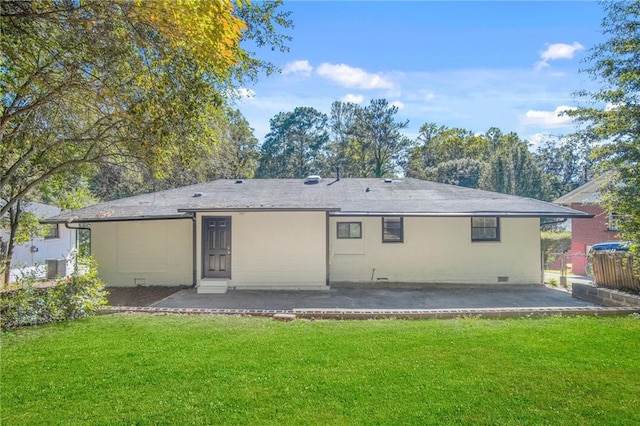 back of property with a yard, cooling unit, and a patio area