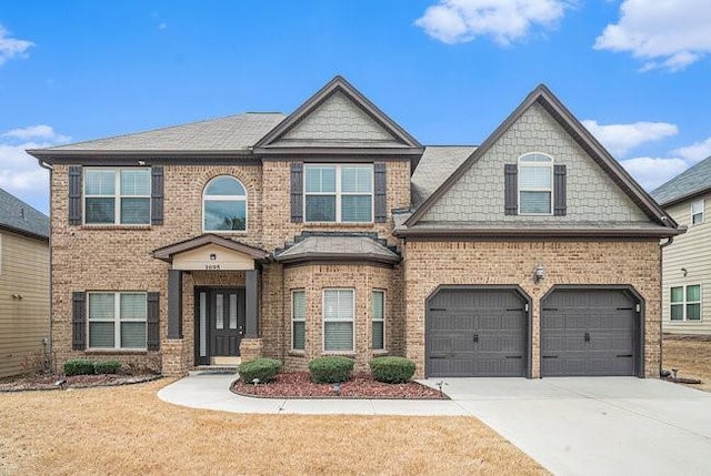 craftsman-style house with brick siding, driveway, and a garage