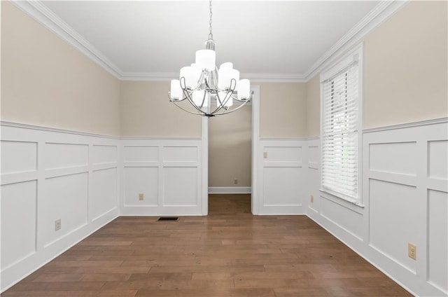 3394 Bryerstone Cir SE, Smyrna, GA 30080 - unfurnished dining area featuring a decorative wall, a chandelier, crown molding, a wainscoted wall, and wood finished floors