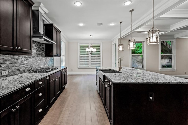 3394 Bryerstone Cir SE, Smyrna, GA 30080 - kitchen with stainless steel gas stovetop, a chandelier, wall chimney exhaust hood, baseboards, and backsplash