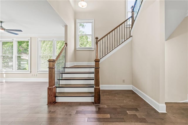 3394 Bryerstone Cir SE, Smyrna, GA 30080 - stairs with wood finished floors, ceiling fan, and baseboards