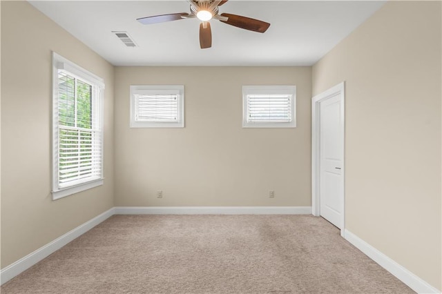 3394 Bryerstone Cir SE, Smyrna, GA 30080 - unfurnished room featuring light carpet, healthy amount of natural light, and a ceiling fan