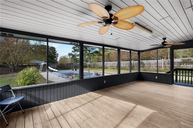 unfurnished sunroom with ceiling fan and plenty of natural light