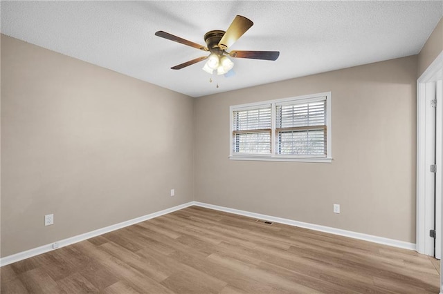 unfurnished room with a textured ceiling, light hardwood / wood-style flooring, and ceiling fan