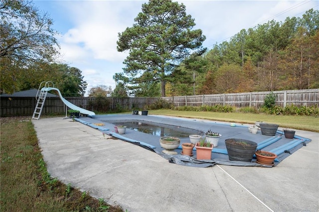 view of pool with a patio and a water slide