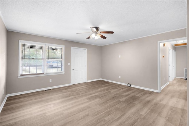 unfurnished room featuring light hardwood / wood-style floors, ceiling fan, a textured ceiling, and crown molding