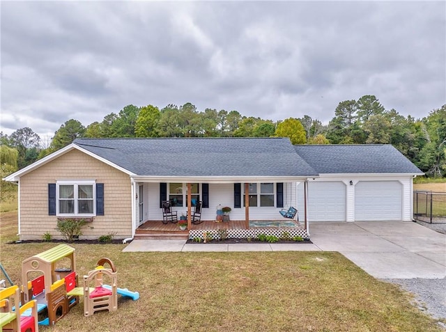 ranch-style house with a garage, a front yard, and covered porch