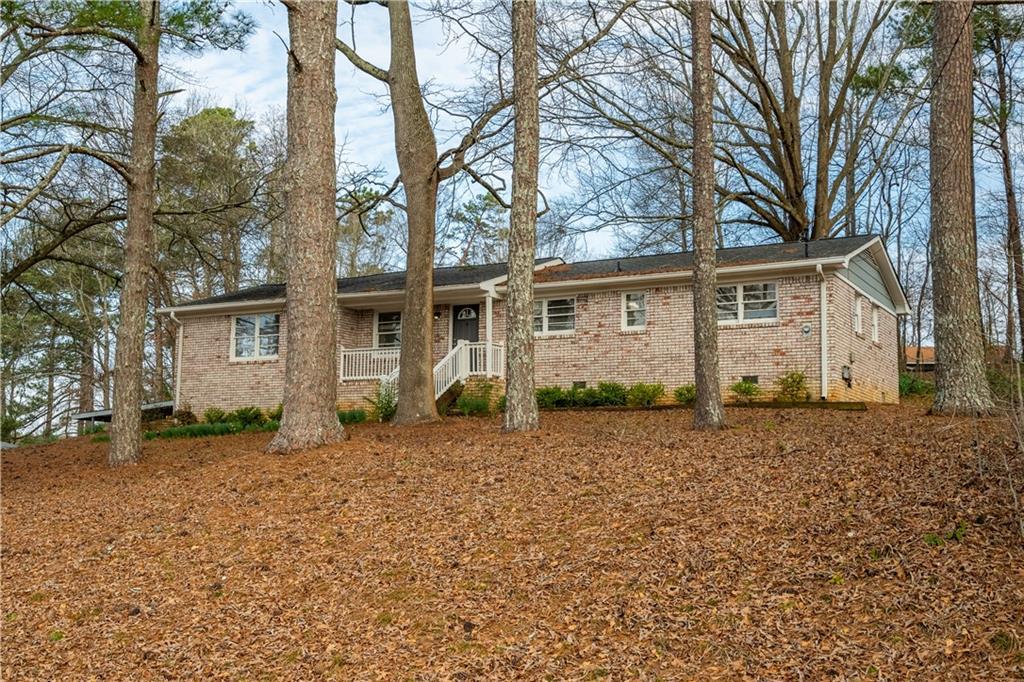 single story home featuring brick siding and crawl space