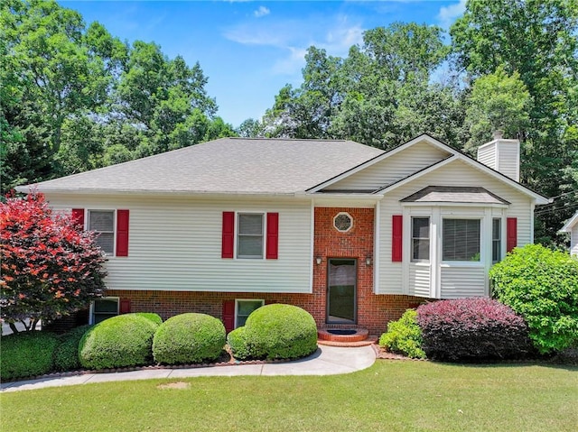 4654 Fox Forrest Dr, Flowery Branch, GA 30542 - raised ranch featuring a front lawn, brick siding, and a chimney