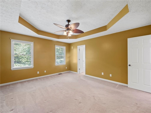 4654 Fox Forrest Dr, Flowery Branch, GA 30542 - unfurnished room featuring a textured ceiling, a tray ceiling, light colored carpet, a ceiling fan, and baseboards