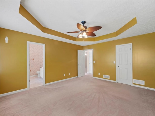 4654 Fox Forrest Dr, Flowery Branch, GA 30542 - unfurnished bedroom featuring a raised ceiling, carpet, baseboards, ensuite bath, and ceiling fan