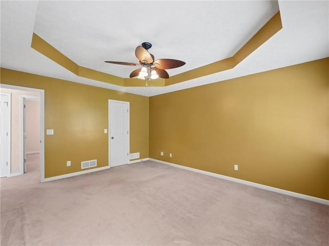 4654 Fox Forrest Dr, Flowery Branch, GA 30542 - unfurnished room with light carpet, a tray ceiling, a ceiling fan, and baseboards