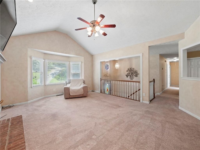 4654 Fox Forrest Dr, Flowery Branch, GA 30542 - sitting room featuring a ceiling fan, carpet, vaulted ceiling, an upstairs landing, and a textured ceiling