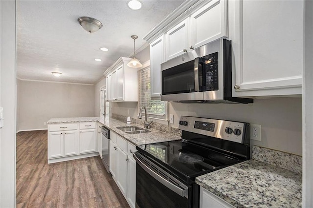 637 Carlouetta Rd SW, Mableton, GA 30126 - kitchen with stainless steel appliances, wood finished floors, white cabinetry, a peninsula, and light stone countertops