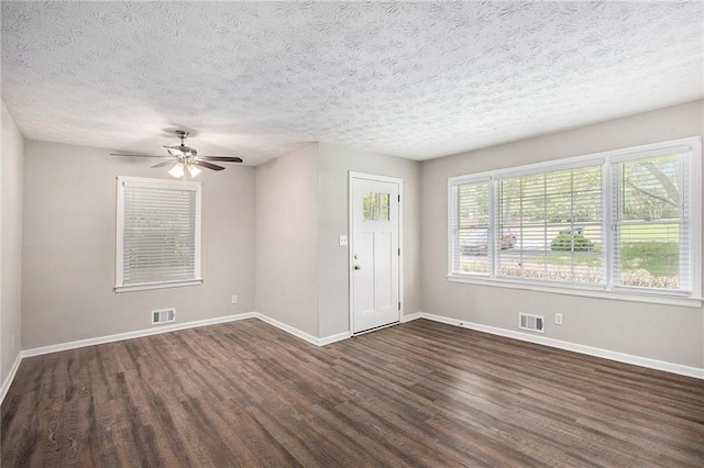 637 Carlouetta Rd SW, Mableton, GA 30126 - unfurnished room with dark wood-style flooring, a ceiling fan, and a textured ceiling
