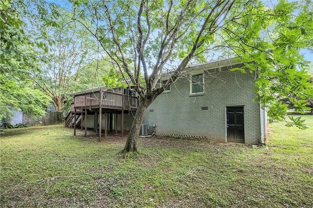 637 Carlouetta Rd SW, Mableton, GA 30126 - back of house with a deck, stairway, brick siding, and a lawn