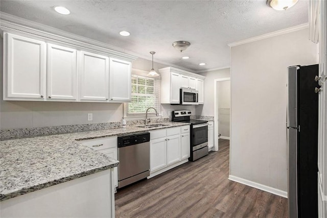 637 Carlouetta Rd SW, Mableton, GA 30126 - kitchen featuring appliances with stainless steel finishes, crown molding, white cabinets, dark wood-type flooring, and light stone countertops