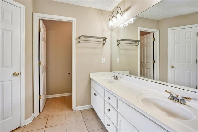 501 Barhams Ridge Dr, Mcdonough, GA 30252 - bathroom featuring baseboards, tile patterned flooring, a sink, and double vanity
