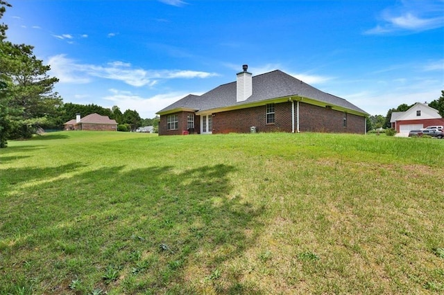 501 Barhams Ridge Dr, Mcdonough, GA 30252 - rear view of house with a chimney, brick siding, and a yard