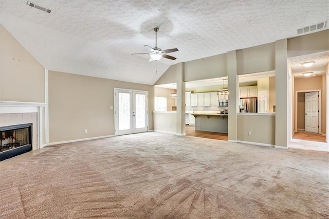 501 Barhams Ridge Dr, Mcdonough, GA 30252 - unfurnished living room featuring vaulted ceiling, visible vents, carpet, and a textured ceiling