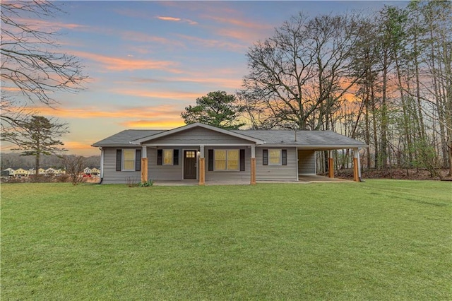 ranch-style house with a lawn, a porch, and a carport