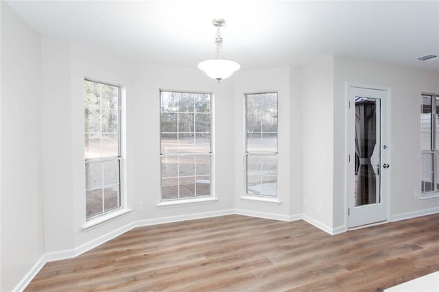 unfurnished dining area featuring light hardwood / wood-style floors