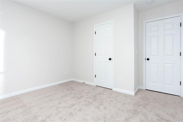 empty room featuring light carpet