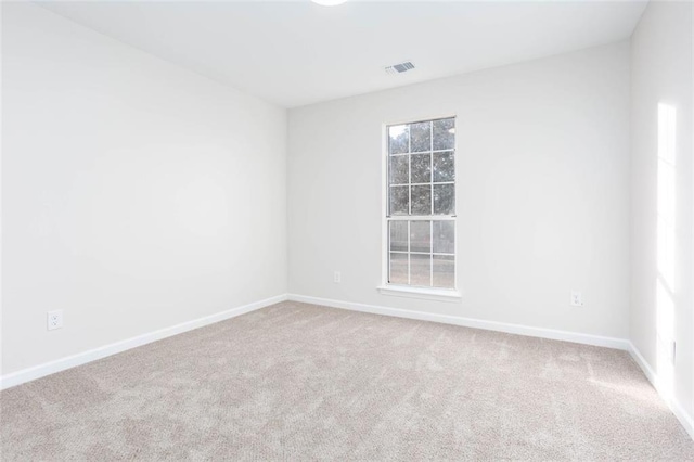 unfurnished room with carpet floors and a wealth of natural light