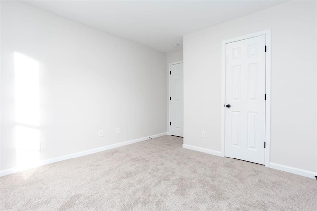 unfurnished bedroom with light carpet