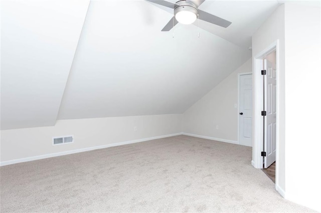 additional living space with ceiling fan, light colored carpet, and lofted ceiling