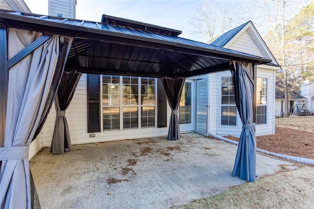 back of house featuring a gazebo