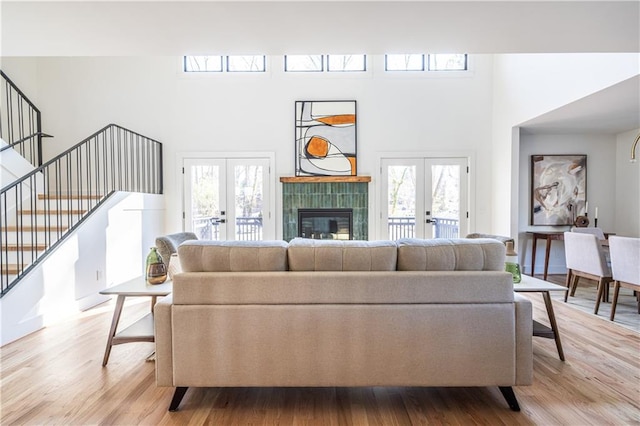 living room featuring french doors and light hardwood / wood-style flooring