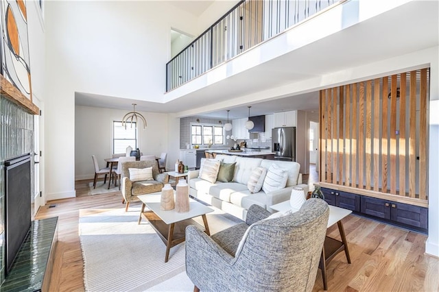 living room featuring a high ceiling and light hardwood / wood-style floors