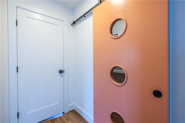 interior space with a barn door and light wood-type flooring